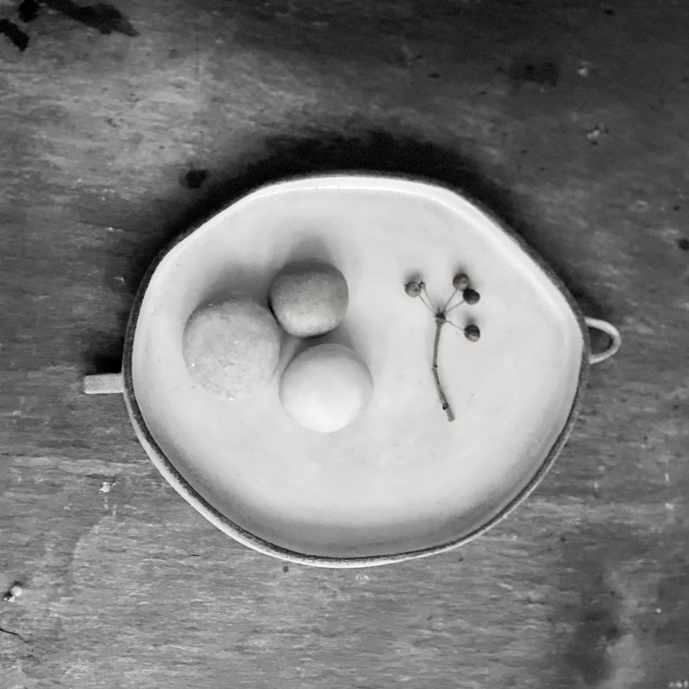 shallow dish with a trio of ceramic pebbles